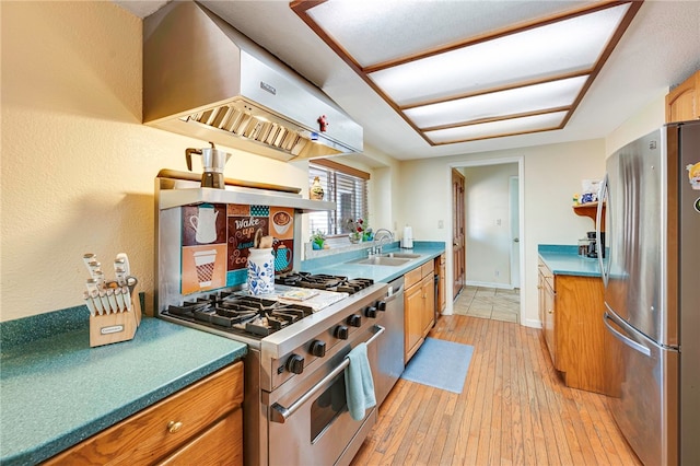 1200 N Cypress St, La Habra Heights, CA 90631 - kitchen with appliances with stainless steel finishes, extractor fan, light wood finished floors, a sink, and brown cabinets