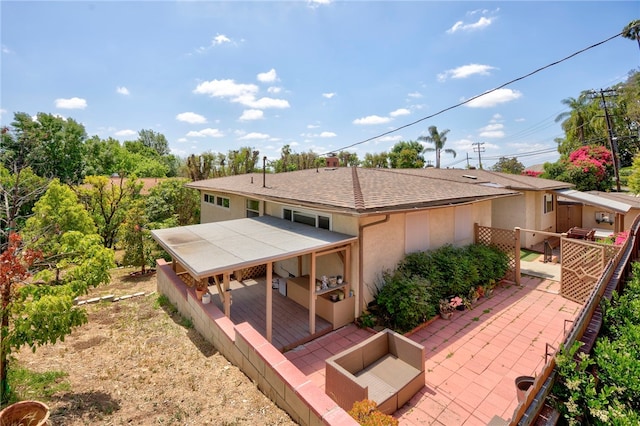 1200 N Cypress St, La Habra Heights, CA 90631 - back of property featuring stucco siding, a patio area, a wooden deck, and a shingled roof