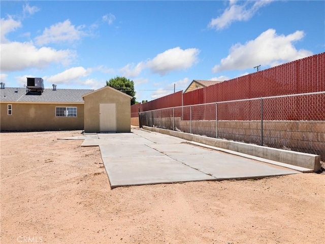 17970 Pitache St, Hesperia, CA 92345 - fenced backyard featuring an outdoor structure and central AC unit