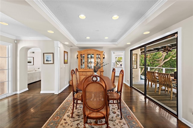 31751 E Nine, Laguna Niguel, CA 92677 - dining room with baseboards, dark wood-type flooring, a tray ceiling, arched walkways, and ornamental molding
