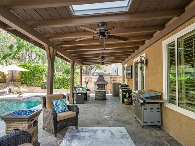 27718 Heartwood Ct, Valencia, CA 91354 - fenced backyard featuring a patio area, a ceiling fan, and a fire pit