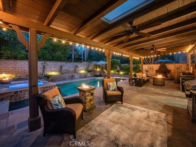 27718 Heartwood Ct, Valencia, CA 91354 - fenced backyard with a fire pit, a patio area, and a pool with connected hot tub