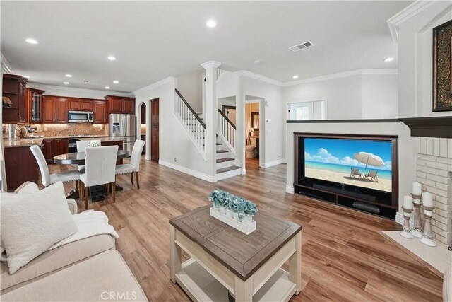 27718 Heartwood Ct, Valencia, CA 91354 - living room with stairs, ornamental molding, baseboards, recessed lighting, and light wood-type flooring