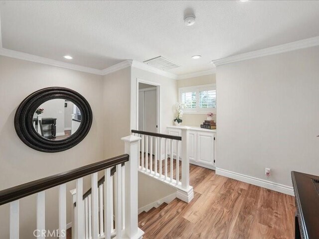 27718 Heartwood Ct, Valencia, CA 91354 - hall featuring an upstairs landing, light wood-style flooring, ornamental molding, recessed lighting, and baseboards