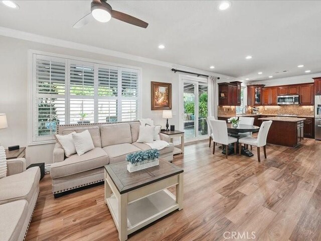 27718 Heartwood Ct, Valencia, CA 91354 - living room with crown molding, a ceiling fan, recessed lighting, and light wood-style floors