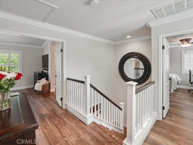27718 Heartwood Ct, Valencia, CA 91354 - hall featuring an upstairs landing, wood finished floors, baseboards, ornamental molding, and recessed lighting