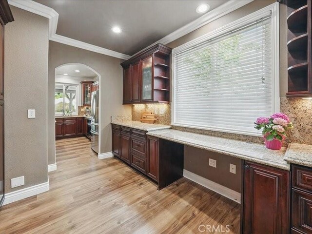 27718 Heartwood Ct, Valencia, CA 91354 - kitchen with freestanding refrigerator, arched walkways, crown molding, open shelves, and light wood-type flooring