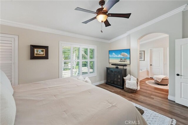 27718 Heartwood Ct, Valencia, CA 91354 - bedroom featuring arched walkways, wood finished floors, crown molding, baseboards, and ceiling fan