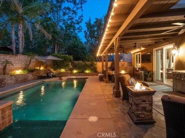 27718 Heartwood Ct, Valencia, CA 91354 - view of swimming pool with a fire pit, a fenced backyard, a ceiling fan, and a patio