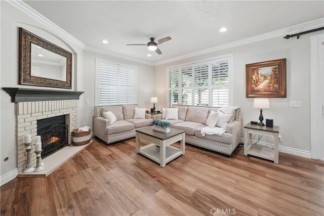 27718 Heartwood Ct, Valencia, CA 91354 - living area featuring ornamental molding, a ceiling fan, wood finished floors, recessed lighting, and a fireplace