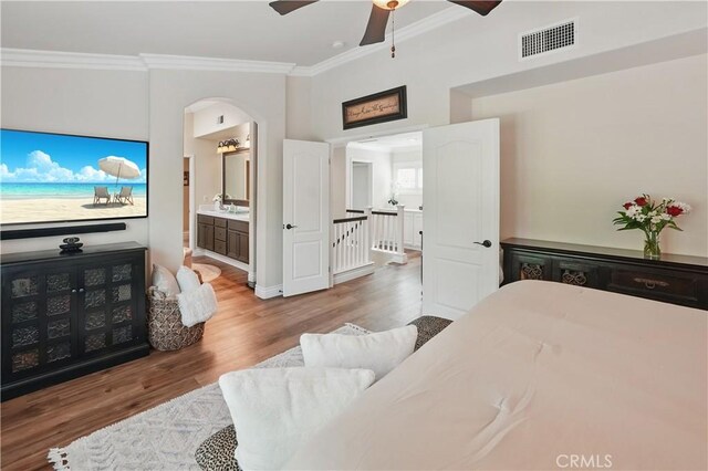 27718 Heartwood Ct, Valencia, CA 91354 - bedroom featuring ornamental molding, wood finished floors, connected bathroom, a ceiling fan, and arched walkways