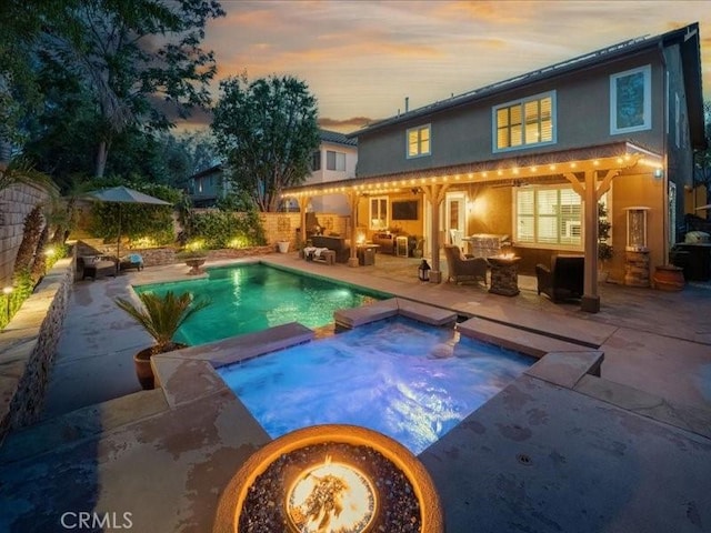 27718 Heartwood Ct, Valencia, CA 91354 - pool at dusk with a patio area, a pool with connected hot tub, and a fenced backyard