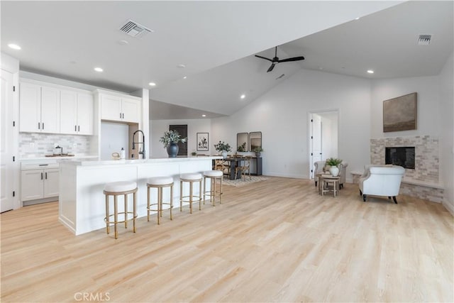 13165 N Bluffs Ct, San Miguel, CA 93451 - kitchen featuring white cabinetry, a kitchen island with sink, recessed lighting, open floor plan, and light wood-style flooring