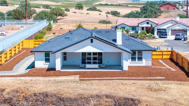 13165 N Bluffs Ct, San Miguel, CA 93451 - back of property featuring stucco siding, a fenced backyard, a chimney, a patio area, and a tile roof