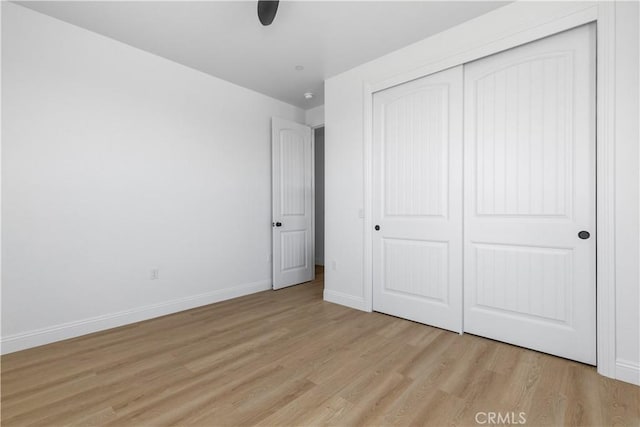 13165 N Bluffs Ct, San Miguel, CA 93451 - unfurnished bedroom with light wood-style floors, baseboards, and a closet