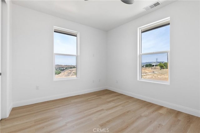 13165 N Bluffs Ct, San Miguel, CA 93451 - empty room with plenty of natural light, light wood finished floors, and baseboards