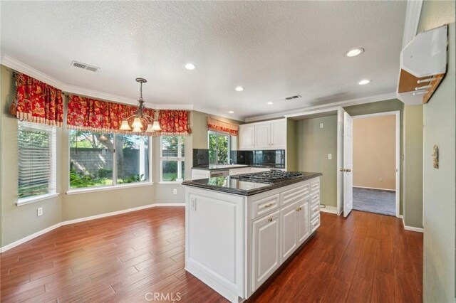 12958 Boston Ave, Chino, CA 91710 - kitchen featuring dark countertops, white cabinets, baseboards, dark wood-type flooring, and ornamental molding