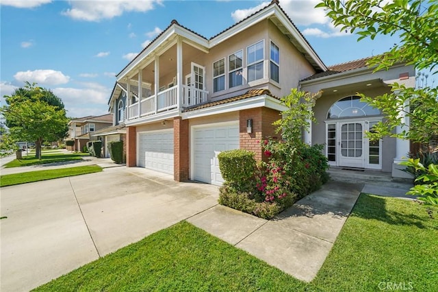 12958 Boston Ave, Chino, CA 91710 - view of front of property with driveway, an attached garage, brick siding, and a front yard