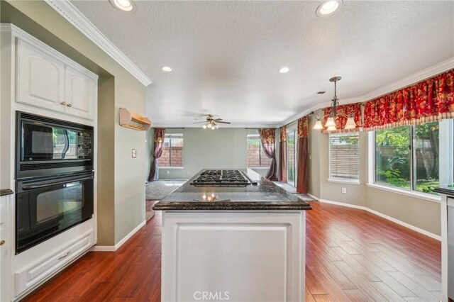 12958 Boston Ave, Chino, CA 91710 - kitchen with black appliances, crown molding, baseboards, wood finished floors, and white cabinetry