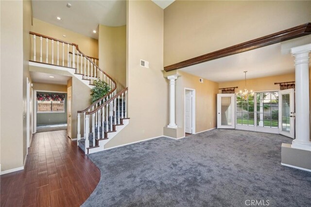 12958 Boston Ave, Chino, CA 91710 - unfurnished living room with ornate columns, baseboards, a chandelier, a towering ceiling, and recessed lighting