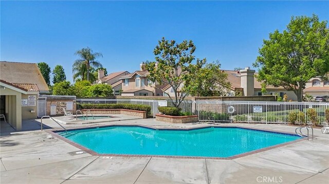 12958 Boston Ave, Chino, CA 91710 - community pool with a community hot tub, a patio area, and a residential view