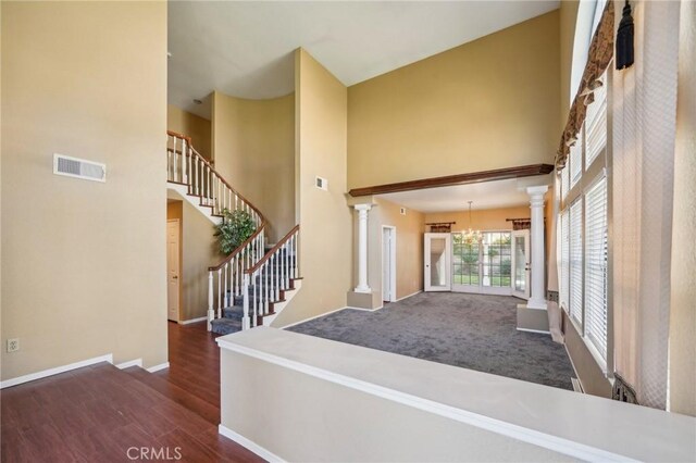 12958 Boston Ave, Chino, CA 91710 - foyer featuring a high ceiling, ornate columns, baseboards, stairway, and wood finished floors
