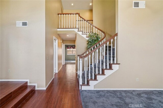12958 Boston Ave, Chino, CA 91710 - stairway with wood finished floors, baseboards, and a high ceiling