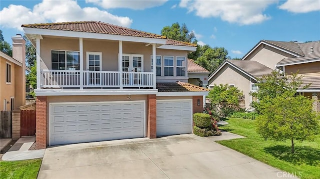 12958 Boston Ave, Chino, CA 91710 - view of front of house featuring a tile roof, a garage, driveway, stucco siding, and brick siding