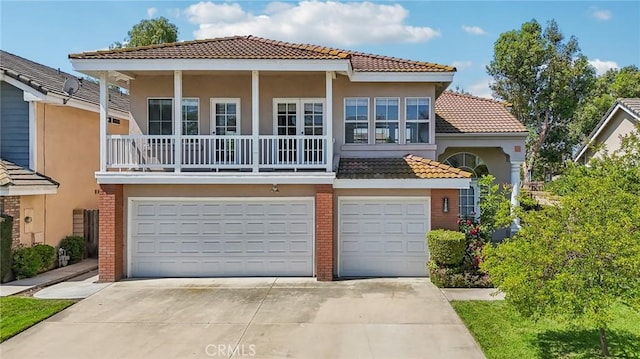 12958 Boston Ave, Chino, CA 91710 - view of front of house with a garage, a tile roof, driveway, stucco siding, and brick siding