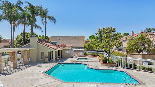 12958 Boston Ave, Chino, CA 91710 - community pool with a patio area, a hot tub, and an outdoor kitchen