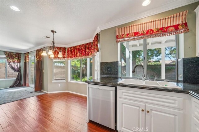 12958 Boston Ave, Chino, CA 91710 - kitchen with dishwasher, a sink, dark wood-style flooring, white cabinetry, and crown molding
