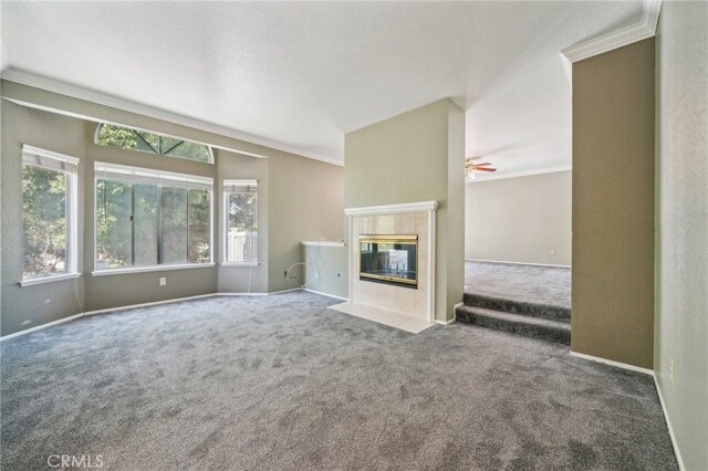 12958 Boston Ave, Chino, CA 91710 - unfurnished living room featuring carpet flooring, crown molding, baseboards, a tile fireplace, and ceiling fan