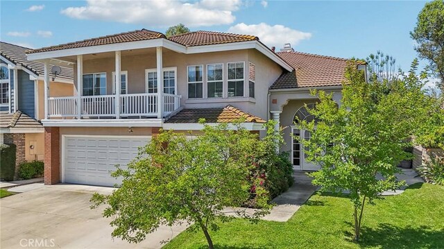12958 Boston Ave, Chino, CA 91710 - view of front facade featuring a tiled roof, stucco siding, driveway, a balcony, and a garage