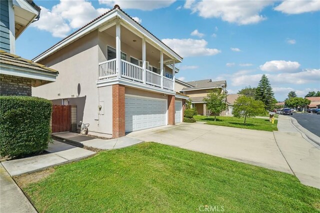 12958 Boston Ave, Chino, CA 91710 - view of property exterior featuring a balcony, stucco siding, driveway, and a garage