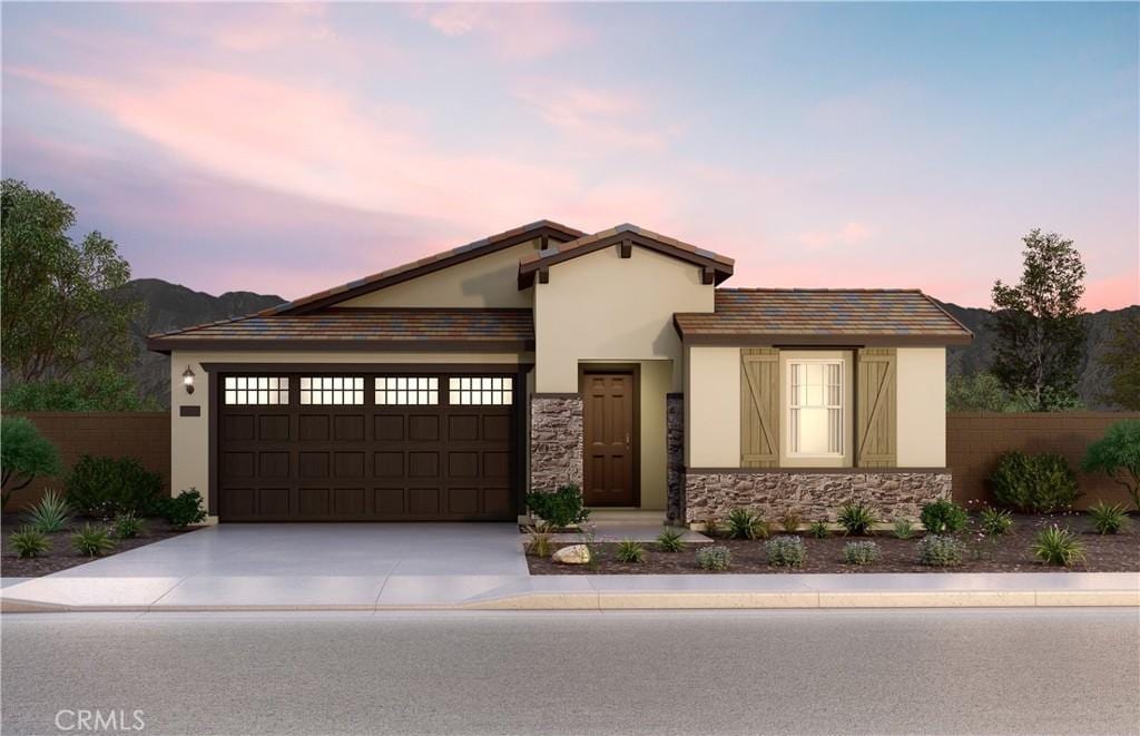 21564 Thomas Ct, Riverside, CA 92507 - view of front facade featuring stucco siding, concrete driveway, a garage, and stone siding