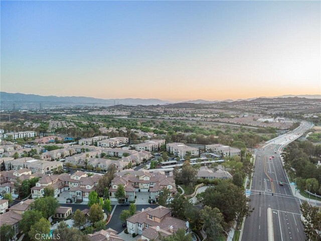 23423 Abbey Glen Pl Unit 30, Valencia, CA 91354 - aerial view of property and surrounding area featuring mountains, a major roadway, and nearby suburban area