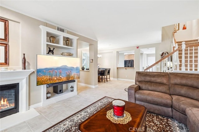 23423 Abbey Glen Pl Unit 30, Valencia, CA 91354 - living area featuring stairway, ornamental molding, a glass covered fireplace, light tile patterned floors, and baseboards