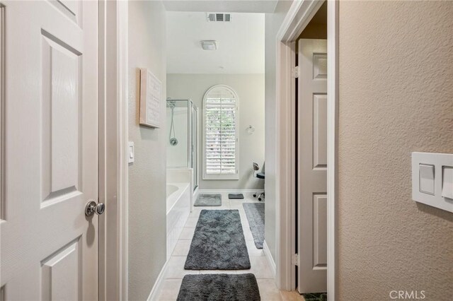 23423 Abbey Glen Pl Unit 30, Valencia, CA 91354 - bathroom featuring tile patterned flooring, washtub / shower combination, and a textured wall