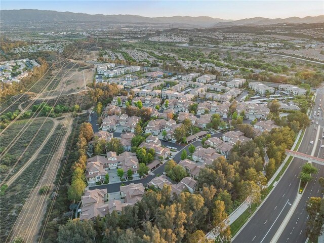 23423 Abbey Glen Pl Unit 30, Valencia, CA 91354 - aerial view of property's location featuring a mountain backdrop, nearby suburban area, and a main thoroughfare