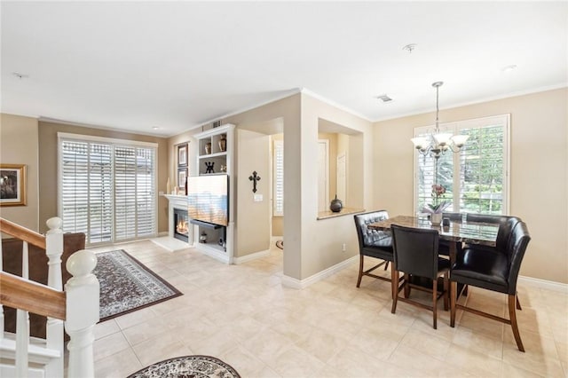 23423 Abbey Glen Pl Unit 30, Valencia, CA 91354 - dining room featuring a chandelier, baseboards, a lit fireplace, and ornamental molding