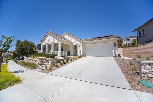 39454 Chamise St, Temecula, CA 92591 - single story home with a porch, concrete driveway, roof mounted solar panels, an attached garage, and stucco siding