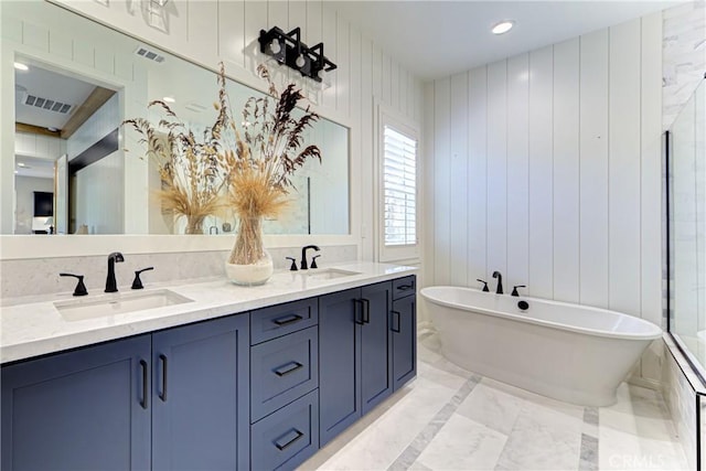 39454 Chamise St, Temecula, CA 92591 - full bathroom with marble finish floors, a freestanding bath, double vanity, wooden walls, and recessed lighting