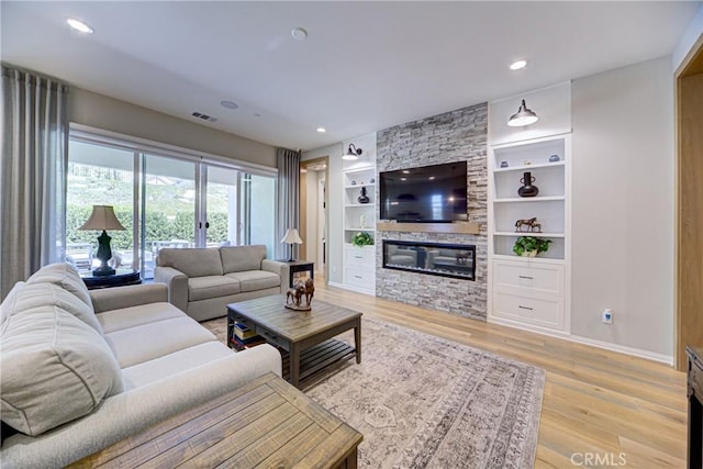 39454 Chamise St, Temecula, CA 92591 - living area with a fireplace, built in features, light wood-style flooring, baseboards, and recessed lighting