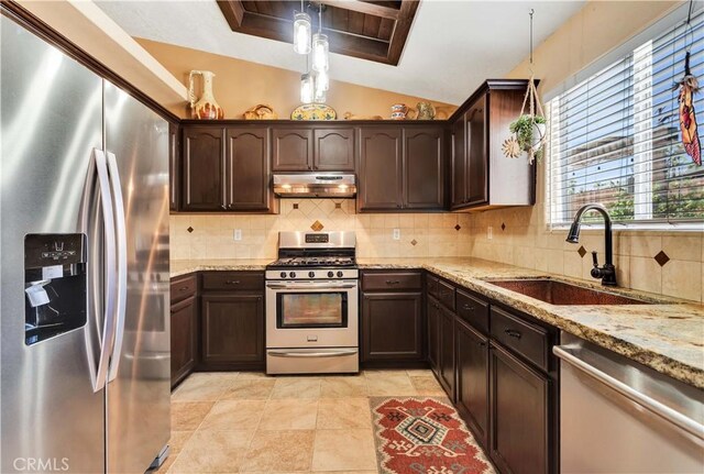 57490 Redondo St, Yucca Valley, CA 92284 - kitchen featuring stainless steel appliances, a sink, under cabinet range hood, dark brown cabinetry, and lofted ceiling
