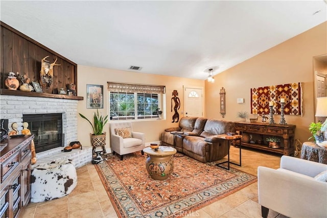 57490 Redondo St, Yucca Valley, CA 92284 - living area featuring a brick fireplace, lofted ceiling, and light tile patterned floors