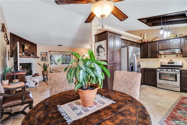 57490 Redondo St, Yucca Valley, CA 92284 - kitchen with appliances with stainless steel finishes, under cabinet range hood, dark brown cabinetry, a ceiling fan, and backsplash