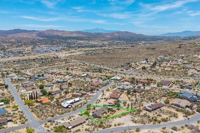 57490 Redondo St, Yucca Valley, CA 92284 - aerial perspective of suburban area featuring a mountainous background and property boundaries highlighted
