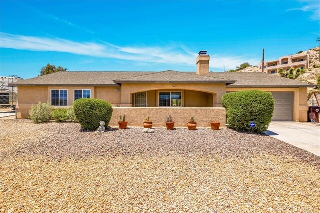 57490 Redondo St, Yucca Valley, CA 92284 - ranch-style house featuring stucco siding, a chimney, and concrete driveway