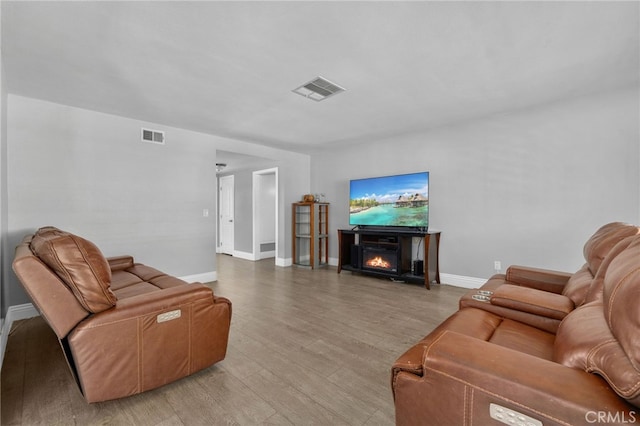 5979 Stanton Ave, Highland, CA 92346 - living room with baseboards, a fireplace, and light wood-style floors