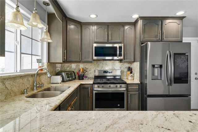 5979 Stanton Ave, Highland, CA 92346 - kitchen with stainless steel appliances, a sink, light stone counters, backsplash, and recessed lighting